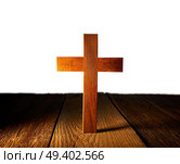 Christian wood cross on white and wooden background. Стоковое фото, агентство Ingram Publishing / Фотобанк Лори