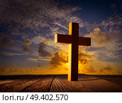 Christian wood cross on sunset sky wooden made. Стоковое фото, агентство Ingram Publishing / Фотобанк Лори