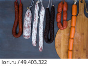 Cured meat and sausages hanging at market. Cured meat and sausages. Стоковое фото, агентство Ingram Publishing / Фотобанк Лори