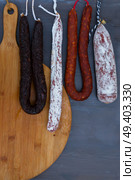 Cured meat and sausages hanging a rack. Cured meat and sausages. Стоковое фото, агентство Ingram Publishing / Фотобанк Лори