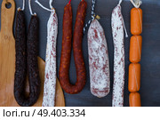Cured meat and sausages hanging a rack. Cured meat and sausages. Стоковое фото, агентство Ingram Publishing / Фотобанк Лори