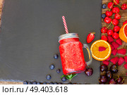 Fresh smoothy red drink in glass jar with igredients on black. Fresh smoothy red drink. Стоковое фото, агентство Ingram Publishing / Фотобанк Лори