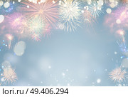 Fireworks colorful explosions on blue, festive background with copy space. Fireworks explosions on black. Стоковое фото, агентство Ingram Publishing / Фотобанк Лори
