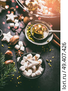 Marshmallow and Christmas star cookies with chocolate and spices: cinnamon, anise and cardamon with nuts on dark background with cozy candle light. Homemade festive sweet gifts preparation. Стоковое фото, агентство Ingram Publishing / Фотобанк Лори