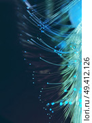 An amazing and vibrant macro of blue fiber optical pipes that illuminate making sparkles and glitters with black background. Стоковое фото, агентство Ingram Publishing / Фотобанк Лори