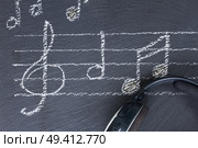 Music notes with treble clef and headphones . Music notes with  headphones . Стоковое фото, агентство Ingram Publishing / Фотобанк Лори