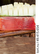 platter of spanish cured pork ham jamon and  melon with copy space on wooden table. platter of ham. Стоковое фото, агентство Ingram Publishing / Фотобанк Лори