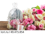 bunch of pink and white fresh roses and eustoma flowers  with present  box on wooden table over white background. pink and white flowers. Стоковое фото, агентство Ingram Publishing / Фотобанк Лори