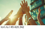 A diverse group of individuals standing together and raising their hands in unison. Стоковое AI-изображение, AI-художник Данила Большаков / Фотобанк Лори