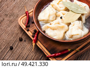 Russian meat dumplings pelmeni on wooden rustic background.Russian pelmeni. Homemade meat dumplings. Стоковое фото, агентство Ingram Publishing / Фотобанк Лори