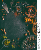 Chocolate background with various nuts and spices topping and flavoring on dark rustic background, top view, frame.  Patisserie , bakery or sweet food concept. Стоковое фото, агентство Ingram Publishing / Фотобанк Лори