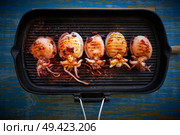 Grilled cuttlefish squid in cast iron grill on wood. Стоковое фото, агентство Ingram Publishing / Фотобанк Лори