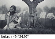 Portrait of a miserable woman doing the laundry during rainy weather. Стоковое фото, агентство Ingram Publishing / Фотобанк Лори