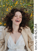 A woman is lying on the ground, laughing heartily. Стоковое AI-изображение, AI-художник Данила Большаков / Фотобанк Лори