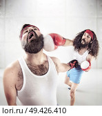 Two nerdy pals boxing on the ring. Стоковое фото, агентство Ingram Publishing / Фотобанк Лори
