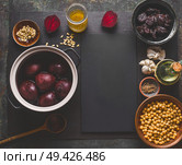 Beet root salad preparation with pine nuts, chickpeas and prunes on dark background, top view with copy space for your design. Healthy clean, low calories food and diet and detox eating concept. Стоковое фото, агентство Ingram Publishing / Фотобанк Лори