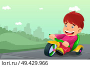 A vector illustration of cute boy riding tricycle in the park. Стоковая иллюстрация, агентство Ingram Publishing / Фотобанк Лори
