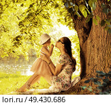 Adorable mother cuddling and kissing her beloved hild. Стоковое фото, агентство Ingram Publishing / Фотобанк Лори