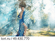 Beautiful young woman wearing the fabulous dress. Стоковое фото, агентство Ingram Publishing / Фотобанк Лори