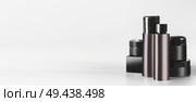 Variety of black and brown cosmetic product jars and bottles with branding mock up, standing on light table at wall background. Snail mucin cosmetic set or charcoal cosmetics. Modern facial skin care. Стоковое фото, агентство Ingram Publishing / Фотобанк Лори