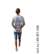 Rear view full length portrait of young man walking and stepping with hands behind his back isolated over white background. Стоковое фото, агентство Ingram Publishing / Фотобанк Лори