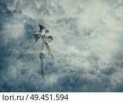 Flying bird carrying a powerless young boy hanging in her claw. Conceptual image symbolizing manipulation and control as a marionette. Стоковое фото, агентство Ingram Publishing / Фотобанк Лори