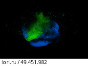 Freeze motion of blue and green powder paint exploding isolated on black, dark background. Abstract design of color dust cloud. Particles explosion screen saver, wallpaper brush. Стоковая иллюстрация, агентство Ingram Publishing / Фотобанк Лори