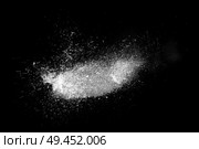 Freeze motion of white powder exploding, isolated on black, dark background. Abstract design of dust cloud. Particles explosion, screen saver wallpaper with copy space. . Стоковая иллюстрация, агентство Ingram Publishing / Фотобанк Лори