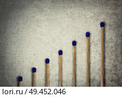 Set of whole, unused matches stacked in a staircase or stairs formation as a financial chart or graph showing business and growth. Стоковое фото, агентство Ingram Publishing / Фотобанк Лори