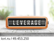 Leverage message on an analog device in orange color in a bright living room. Стоковое фото, агентство Ingram Publishing / Фотобанк Лори
