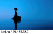 A woman is sitting in the water, looking up at the sky. Стоковое AI-изображение, AI-художник Ярославский Максим / Фотобанк Лори
