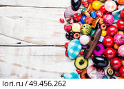 Variety of shapes and colors to make a bead necklace. Colorful beads on wooden surface. Стоковое фото, агентство Ingram Publishing / Фотобанк Лори