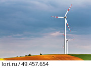 Spring sunny day, green fields with wind power generators. Eco power. Wind turbines park generating electricity. Hunting box on top of the hill. Lower Austria near Poysdorf. Стоковое фото, агентство Ingram Publishing / Фотобанк Лори