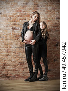 Family in leather clothes on brick wall background (HDR ver) Стоковое фото, агентство Ingram Publishing / Фотобанк Лори