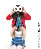Funny geek man sitting on the lavatory. Стоковое фото, агентство Ingram Publishing / Фотобанк Лори