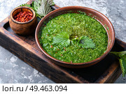 Nettle soup in bowl on wooden surface.Green nettle soup. Homemade soup made of nettles. Стоковое фото, агентство Ingram Publishing / Фотобанк Лори