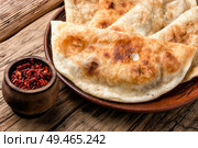Cheburek, unleavened patty stuffed with minced meat.Cheburek, the national dish of the Crimean Tatars. Cheburek,dough pie with meat filling. Стоковое фото, агентство Ingram Publishing / Фотобанк Лори