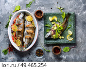 Trout with bacon baked in the oven. Fish with vegetables. Trout with bacon and vegetables. Стоковое фото, агентство Ingram Publishing / Фотобанк Лори