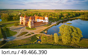 Aerial view of Medieval Mir castle complex at spring sunset. Famous landmark, UNESCO world heritage. Drone panorama of Mirsky zamok, Belarus. Стоковое фото, агентство Ingram Publishing / Фотобанк Лори