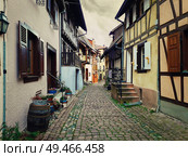 Narrow streets of the old Eguisheim village with half-timbered medieval houses along the famous wine route in Alsace, France. Стоковое фото, агентство Ingram Publishing / Фотобанк Лори