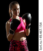 Young sporty girl on black background. Стоковое фото, агентство Ingram Publishing / Фотобанк Лори