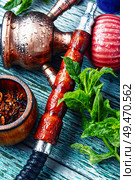 East smoking hookah with mint flavor.Modern kalian with spearmint. Turkish hookah with mint. Стоковое фото, агентство Ingram Publishing / Фотобанк Лори