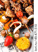 Summer picnic with shashlik and lotto board game.Barbecue and board games.Kebab. Kebabs and lotto game. Стоковое фото, агентство Ingram Publishing / Фотобанк Лори