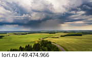 Storm dark clouds over field. Thunderstorm over a wheat field. Rural scene in Belarus, Europe. Стоковое фото, агентство Ingram Publishing / Фотобанк Лори