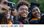 Group of graduates in cap and gown smiling for a selfie during their graduation ceremony. Стоковое AI-изображение, AI-художник Данила Большаков / Фотобанк Лори