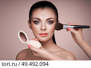 Beautiful Woman applies Skin Tone with Brush. Beautiful Woman face. Perfect Makeup. Skincare Foundation. Brushes Makeup Artist. Стоковое фото, агентство Ingram Publishing / Фотобанк Лори