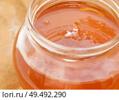fresh bright amber color honey with bubbles in jar. The texture of the honey. Healthy food concept. . Стоковое фото, агентство Ingram Publishing / Фотобанк Лори