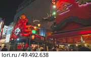 Osaka, Japan - Sep 21 2024, 4k, Panoramic view of Dotonbori street with various cafes, restaurants, bright signs and advertisements, illumination, a lot of people walking, at night, Osaka, Japan. Редакционное видео, видеограф Сергей Богомяко / Фотобанк Лори