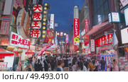 Osaka, Japan - Sep 22 2024, 4k, Panoramic view of Dotonbori street with various cafes, restaurants, bright signs and advertisements, illumination, a lot of people walking, at night, Osaka, Japan. Редакционное видео, видеограф Сергей Богомяко / Фотобанк Лори