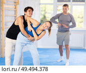 Guy and woman train to perform defense of strangling opponent, while learning self-defense. Стоковое фото, фотограф Яков Филимонов / Фотобанк Лори